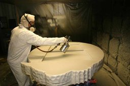 Guy spraying fast set spray onto product