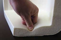 Person pressing down on flexible foam